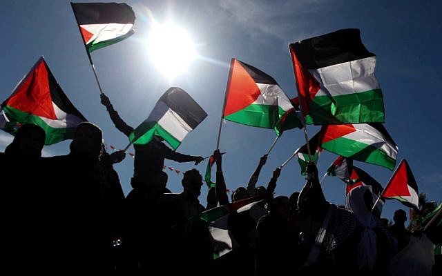 Palestinians wave their national flag during a rally marking the UN General Assembly's upgrading of the Palestinians' status in Ramallah, on Sunday, December 2. (photo credit: Issam Rimawi/Flash90) Palestinians wave their national flag during a rally marking the UN General Assembly's upgrading of the Palestinians' status in Ramallah, on Sunday, December 2. (photo credit: Issam Rimawi/Flash90)