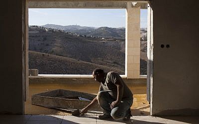 A Palestinian man working in construction in the settlement of Ma'aleh Adumim, near the E1 tract. (photo credit: Yonatan Sindel/Flash90)