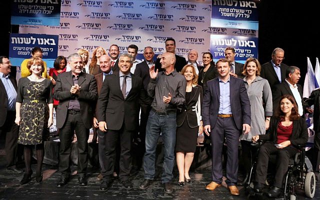 Yesh Atid Chairman Yair Lapid, center with tie, surrounded by his fellow party members after announcing their list for the upcoming Knesset elections in early December, 2012. Most of his list comprises new MKs, 19 of whom are entering the next Knesset. (photo credit: Yehoshua Yosef/Flash90) Yesh Atid Chairman Yair Lapid, center with tie, surrounded by his fellow party members after announcing their list for the upcoming Knesset elections in early December, 2012. Most of his list comprises new MKs, 19 of whom are entering the next Knesset. (photo credit: Yehoshua Yosef/Flash90)