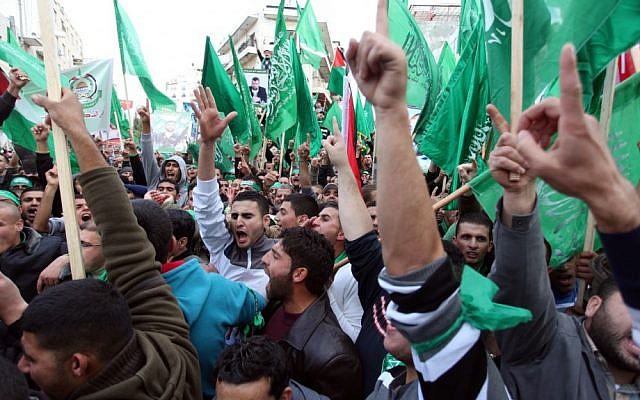 Palestinian supporters of Hamas at a rally marking the terrorist organization's 25th anniversary in the West Bank city of Ramallah (photo credit: Issam Rimawi/Flash90) Palestinian supporters of Hamas at a rally marking the terrorist organization's 25th anniversary in the West Bank city of Ramallah (photo credit: Issam Rimawi/Flash90)