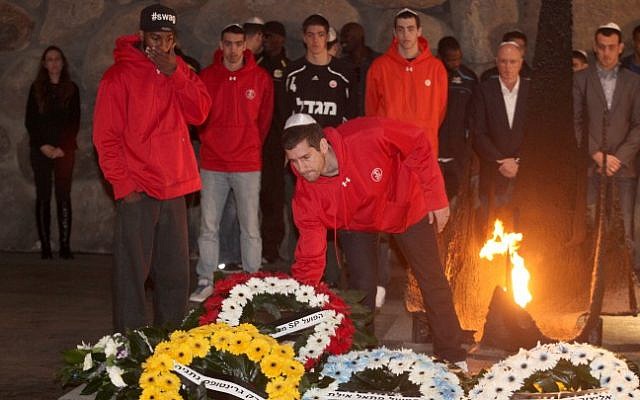 Israeli basketball players visit the Yad Vashem Holocaust memorial on Wednesday, December 19 (photo credit: Isaac Harari/Flash90) Israeli basketball players visit the Yad Vashem Holocaust memorial on Wednesday, December 19 (photo credit: Isaac Harari/Flash90)