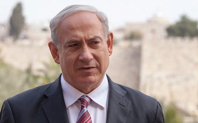 Prime Minister Benjamin Netanyahu stands in front of the Old City walls in Jerusalem, Wednesday, December 19 (photo credit: Uri Lenz/Flash 90)