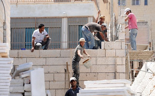 An illustrative photo of workers building a home in East Jerusalem's Ramat Shlomo neighborhood, June 2011. (photo credit: Gili Yaari/Flash90) An illustrative photo of workers building a home in East Jerusalem's Ramat Shlomo neighborhood, June 2011. (photo credit: Gili Yaari/Flash90)