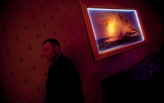 A Russian-speaking Israeli security guard works the VIP room of the Russian Soho nightclub in Tel Aviv. (photo credit: AP Photo/Oded Balilty)