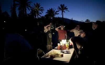 Russian-speaking immigrants drink vodka during a Russian folk music festival at the Gan HaShlosha national park near the northern Israeli Town of Beit Shean. (photo credit: AP Photo/Oded Balilty)