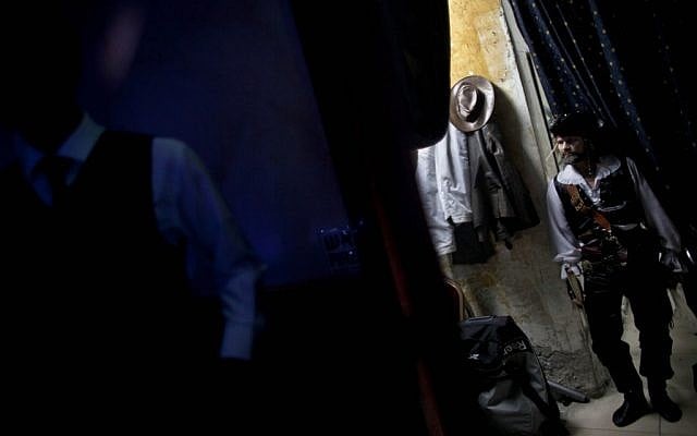Acrobats wait in a dressing room before their show at L'Chaim, a Russian restaurant in Ashdod. Many circus performers emigrated to Israel from the former Soviet Union, and acrobatic shows are a unique feature of Russian restaurants in Israel (photo credit: AP Photo/Oded Balilty)