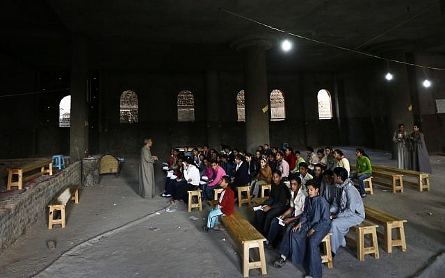 Children attend a class in a church in the village of El-Aziyah near the city of Assiut in southern Egypt this week. (photo credit: AP/Petr David Josek)