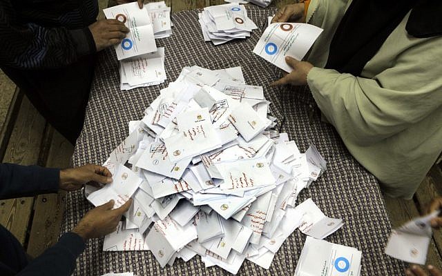 Egyptian referendum officials count votes at a polling station in Cairo, Saturday (photo credit: Amr Nabil/AP)