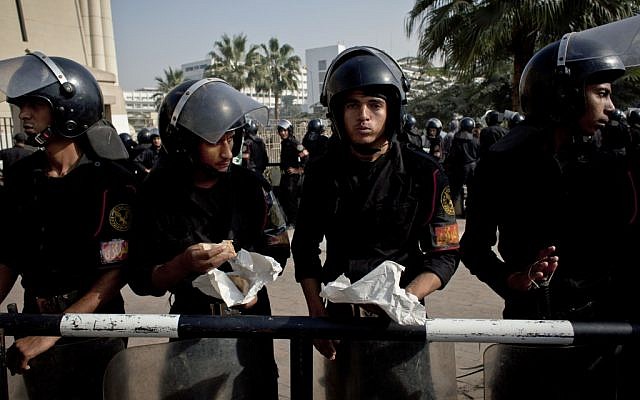 Riot policemen stand guard in front of Egypt’s top court during a protest for supporters of Egyptian President Mohammed Morsi in Cairo on Monday, Dec. 3, 2012. (photo credit: Nasser Nasser/AP) Riot policemen stand guard in front of Egypt’s top court during a protest for supporters of Egyptian President Mohammed Morsi in Cairo on Monday, Dec. 3, 2012. (photo credit: Nasser Nasser/AP)