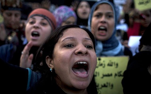 Women protesters opposing Egyptian President Mohammed Morsi chant slogans during a demonstration that started in front of el-Nour mosque, background, in Cairo, Egypt, Tuesday, Dec. 11, 2012 (photo credit: AP/Nasser Nasser)