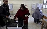 An Egyptian woman casts her vote during a referendum on a disputed constitution drafted by Islamist supporters of President Morsi in Cairo, Egypt, Saturday, Dec. 15, 2012. (photo credit: AP Photo/Khalil Hamra)