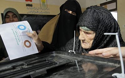 Amnah Sayyed Moussa, 85, casts her vote for the second round of a referendum on a disputed constitution drafted by Islamist supporters of President Mohammed Morsi in Giza, Egypt, Saturday, December 22, 2012 (photo credit:AP/Amr Nabil)