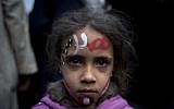 A girl with the colors of Egypt's national flag and Arabic text that reads 'Egypt, Morsi,' painted, at a demonstration in front of Egypt’s top court in Cairo, Sunday, December 2, 2012 (photo credit: AP/Nasser Nasser)