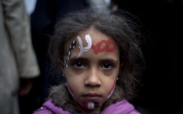 A girl with the colors of Egypt's national flag and Arabic text that reads 'Egypt, Morsi,' painted, at a demonstration in front of Egypt’s top court in Cairo, Sunday, December 2, 2012 (photo credit: AP/Nasser Nasser) A girl with the colors of Egypt's national flag and Arabic text that reads 'Egypt, Morsi,' painted, at a demonstration in front of Egypt’s top court in Cairo, Sunday, December 2, 2012 (photo credit: AP/Nasser Nasser)