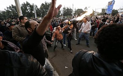 Egyptian President Mohammed Morsi’s supporters and opponents clash outside the presidential palace, in Cairo, Egypt, Wednesday, Dec. 5, 2012 (photo credit: AP/Hassan Ammar)