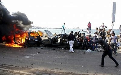 Cars burn during clashes between supporters and opponents of President Mohammed Morsi in Alexandria, Egypt, Friday, Dec. 14 (photo credit: AP/Ahmed Ramadan)