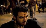An injured Egyptian anti-government protester waits for medical care during clashes between supporters of president Mohammed Morsi and their rivals in front of the president palace, in Cairo, Egypt, Wednesday, Dec. 5, 2012 (photo credit: AP/Nasser Nasser)