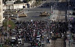 Egyptian army tanks secure the perimeter of the presidential palace while protesters gather chanting anti president Mohammed Morsi slogans, in Cairo, Egypt, on Friday, December 7. (photo credit: AP/Nasser Nasser)