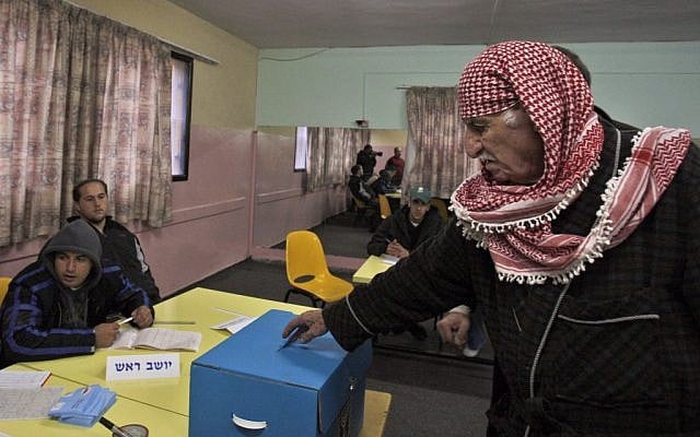 An elderly Israeli Arab man, right, casts his ballot in a polling station in the northern Israeli city of Nazareth, February 10, 2009 (photo credit: AP/Muhammed Muheisen, File)