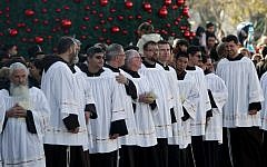 Catholic priests attend Christmas celebrations in the West Bank town of Bethlehem, Monday (photo credit: Nasser Shiyoukhi/AP)