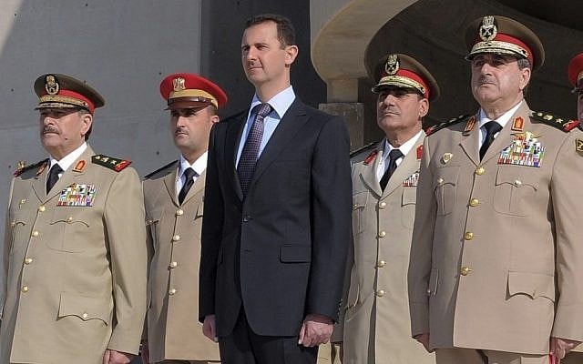 Syrian President Bashar Assad, center, stands next to Syrian Defense Minister Gen. Dawoud Rajha, right, and Chief of Staff Gen. Fahed al-Jasem el-Freij, left, during a ceremony to mark the 38th anniversary of the October 1973 Arab-Israeli war, in Damascus, Syria, in 2011. (AP Photo/SANA) Syrian President Bashar Assad, center, stands next to Syrian Defense Minister Gen. Dawoud Rajha, right, and Chief of Staff Gen. Fahed al-Jasem el-Freij, left, during a ceremony to mark the 38th anniversary of the October 1973 Arab-Israeli war, in Damascus, Syria, in 2011. (AP Photo/SANA)