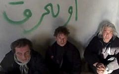 NBC chief foreign correspondent Richard Engel (center), with NBC Turkey reporter Aziz Akyavas (left), and NBC photographer John Kooistra (right), after they were taken hostage in Syria. Undated amateur video posted on the Internet. (photo credit: AP)