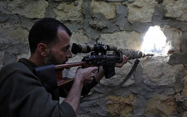 A rebel sniper aims at a Syrian army position on the outskirts of Aleppo last month (photo credit: AP/Khalil Hamra)
