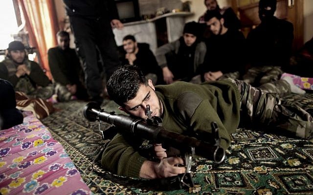 In this Monday, December 17, 2012 photo, Syrian rebels listen to their trainer teaching them how to use the RPG in Maaret Ikhwan, near Idlib, Syria (photo credit: AP/Mohammed Muheisen) In this Monday, December 17, 2012 photo, Syrian rebels listen to their trainer teaching them how to use the RPG in Maaret Ikhwan, near Idlib, Syria (photo credit: AP/Mohammed Muheisen)