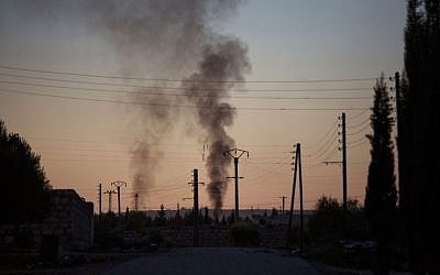 Smoke rises up after intense fighting between Syrian Army and FSA in a military base in Tal Sheen, Syria, on Saturday, December 15, 2012 (photo credit: AP Photo/Manu Brabo)