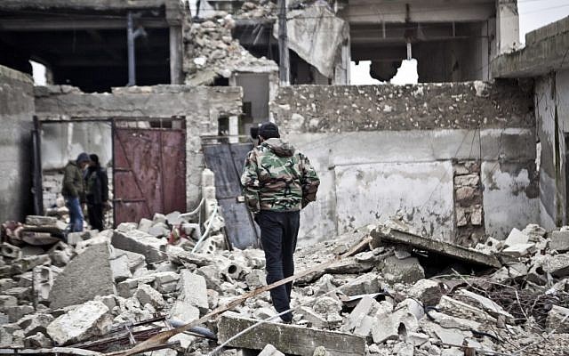 Free Syrian Army fighters walk amid the ruins of a village situated a short distance from an area where fighting between rebels and government forces continues, Saturday, December 22, 2012 (photo credit: AP/Virginie Nguyen Hoang) Free Syrian Army fighters walk amid the ruins of a village situated a short distance from an area where fighting between rebels and government forces continues, Saturday, December 22, 2012 (photo credit: AP/Virginie Nguyen Hoang)