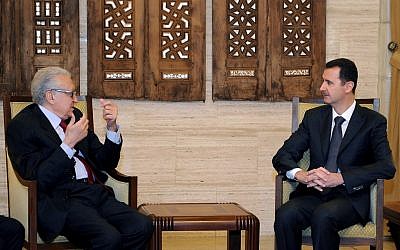 Syrian President Bashar Assad, right, meets with UN Arab League envoy to Syria, Lakhdar Brahimi, in Damascus on Monday, Dec. 24, 2012. (photo credit: SANA/AP)