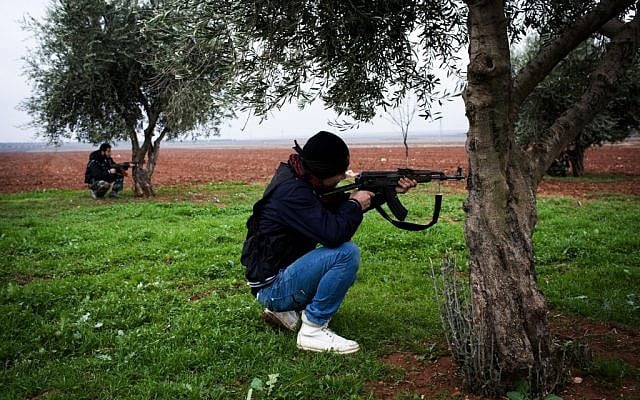 Free Syrian Army fighters aim their weapons outside a military base near Azaz, Syria, Monday, Dec. 10, 2012. (photo credit: Manu Brabo/AP)