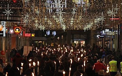 People walk with torches to protest against the awarding of the Nobel Peace Prize to the EU bloc in Oslo, Norway, Sunday December 9, 2012 (photo credit: AP/Yves Logghe)