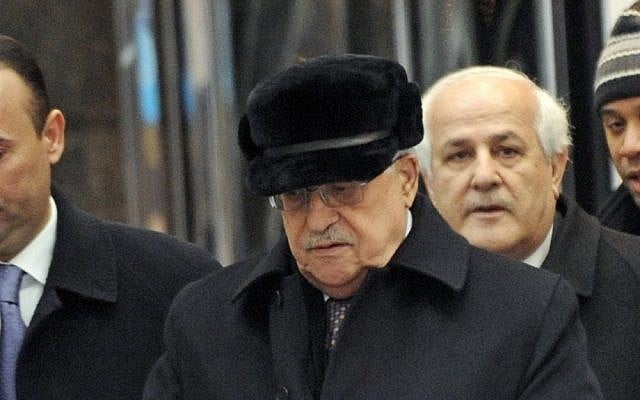 Palestinian Authority President Mahmoud Abbas, center, leaves the United Nations Plaza Hotel on Friday (photo credit: AP/Louis Lanzano)