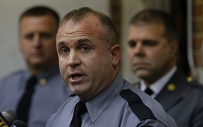 Pennsylvania state trooper Jeff Pettuci talks during a news conference at the Geeseytown Fire Company about shootings along a nearby rural road that left four people dead, including the gunman, and three Pennsylvania State troopers injured on Friday in Geeseytown, Pa. (photo credit: AP Photo/Keith Srakocic)