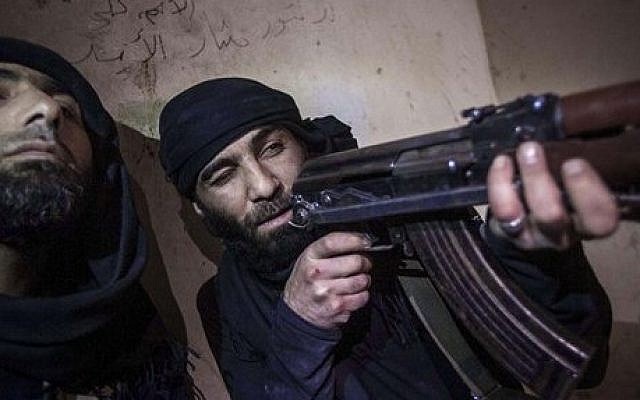 A rebel fighter with the Free Syrian Army takes aim during a battle with government troops in Aleppo, Syria, on Wednesday (photo credit: AP/Narciso Contreras)