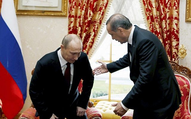 Russian President Vladimir Putin sits down as Turkey's then-prime minister Recep Tayyip Erdogan looks on before a meeting in Istanbul, Turkey, December 3, 2012. (AP/Tolga Bozoglu, Pool) Russian President Vladimir Putin sits down as Turkey's then-prime minister Recep Tayyip Erdogan looks on before a meeting in Istanbul, Turkey, December 3, 2012. (AP/Tolga Bozoglu, Pool)