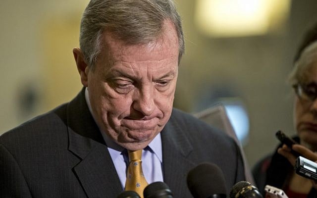 Senator Dick Durbin, D-Ill., a member of the Senate Foreign Relations Committee, pauses as he speaks to reporters following a closed-door briefing on the investigation of the deadly Sept. 11 attack on the U.S. consulate in Benghazi, Libya, at the Capitol in Washington, Wednesday, Dec. 19, 2012. (photo credit: AP/J. Scott Applewhite)