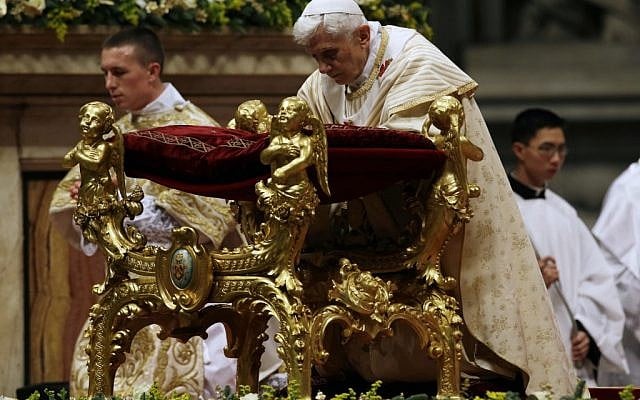 Pope Benedict XVI kneels as he celebrates the Christmas Eve Mass in St. Peter's Basilica at the Vatican on Monday, Dec. 24, 2012. (photo credit: Gregorio Borgia/AP)