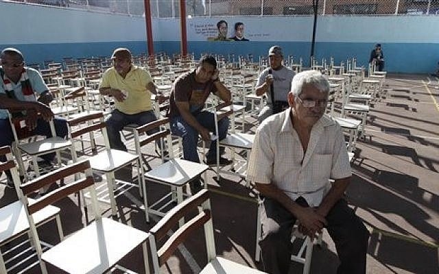 Venezuelans wait to cast their ballots at a polling station in the capital, Caracas, on Sunday (photo credit: AP/Ariana Cubillos) Venezuelans wait to cast their ballots at a polling station in the capital, Caracas, on Sunday (photo credit: AP/Ariana Cubillos)