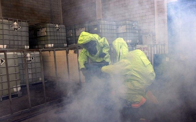 Israeli firemen wear gas masks as they take part in a drill simulating a chemical missile attack in the industrial zone of the southern Israeli city of Kiryat Malachi in 2009 (photo credit: Tsafrir Abayov/Flash90) Israeli firemen wear gas masks as they take part in a drill simulating a chemical missile attack in the industrial zone of the southern Israeli city of Kiryat Malachi in 2009 (photo credit: Tsafrir Abayov/Flash90)