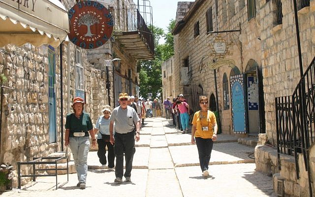 Tourists walk down the street in the northern Israeli city of Safed. Tourists walk down the street in the northern Israeli city of Safed.