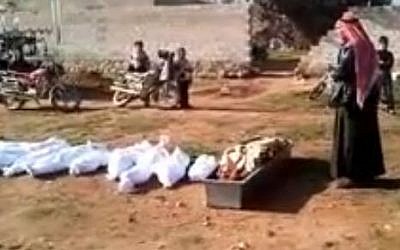 A mass burial in Syria on Saturday from a video uploaded by the Local Coordination Committees (photo credit: screen capture/Youtube)