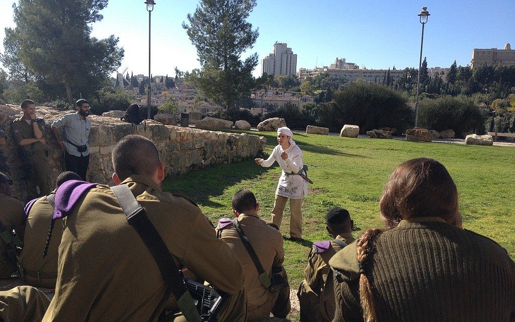 An actor with the Western Wall Heritage Foundation speaking to the soldiers on their way to the Western Wall (photo credit: Mitch Ginsburg/Times of Israel) An actor with the Western Wall Heritage Foundation speaking to the soldiers on their way to the Western Wall (photo credit: Mitch Ginsburg/Times of Israel)