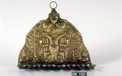 The menorah was fashioned, apparently in Italy, from a plate that once adorned the hat of an Austro-Hungarian soldier (Courtesy of the U. Nahon Museum of Italian Jewish Art)