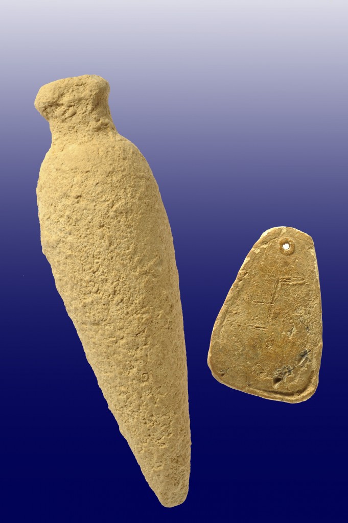 A perfume bottle and a lead weight bearing a carved letter were found at the Kiryat Hayovel dig (Courtesy of the Israel Antiquities Authority)