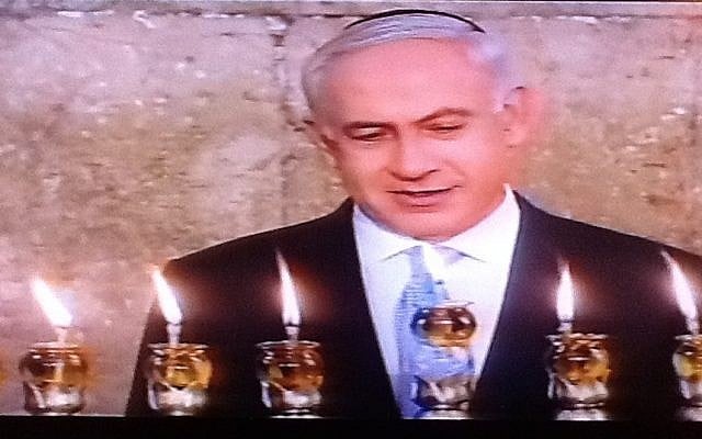 Prime Minister Benjamin Netanyahu lights Hanukkah candles in the Old City on Saturday, the last night of the festival (photo credit: Channel 2 screenshot) Prime Minister Benjamin Netanyahu lights Hanukkah candles in the Old City on Saturday, the last night of the festival (photo credit: Channel 2 screenshot)