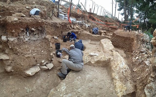 Workers uncover the foundations of ancient buildings under a road in the Jerusalem neighborhood of Kiryat Hayovel (Courtesy of the Israel Antiquities Authority)