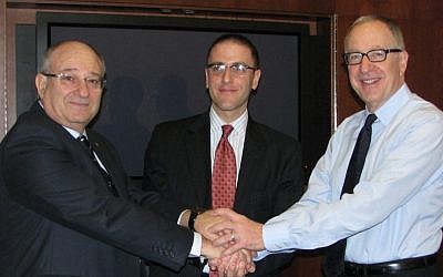 (L. to R.) Cornell University President David J. Skorton, New York City Economic Development Corporation President Seth Pinsky, and Technion President Peretz Lavie shake hands after signing documents establishing the Cornell-Technion center (Photo credit: Courtesy)