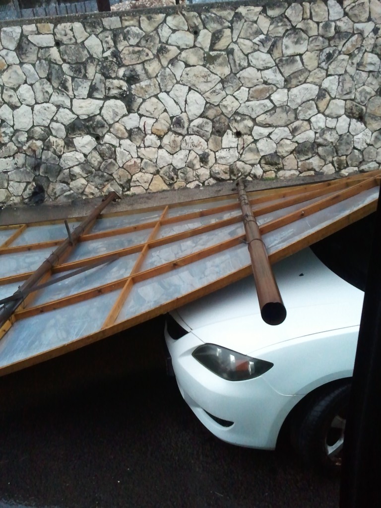A billboard that collapsed on a car in Jerusalem, Monday (photo credit: Elie Klein)